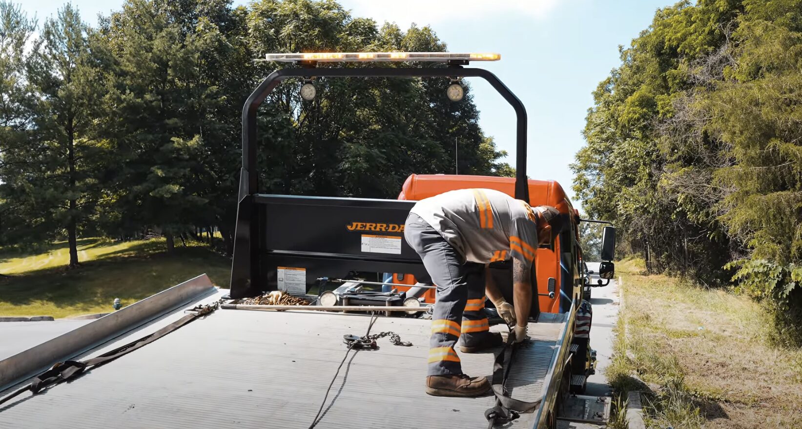 Heavy-duty towing operator preparing specialized equipment for commercial vehicle recovery