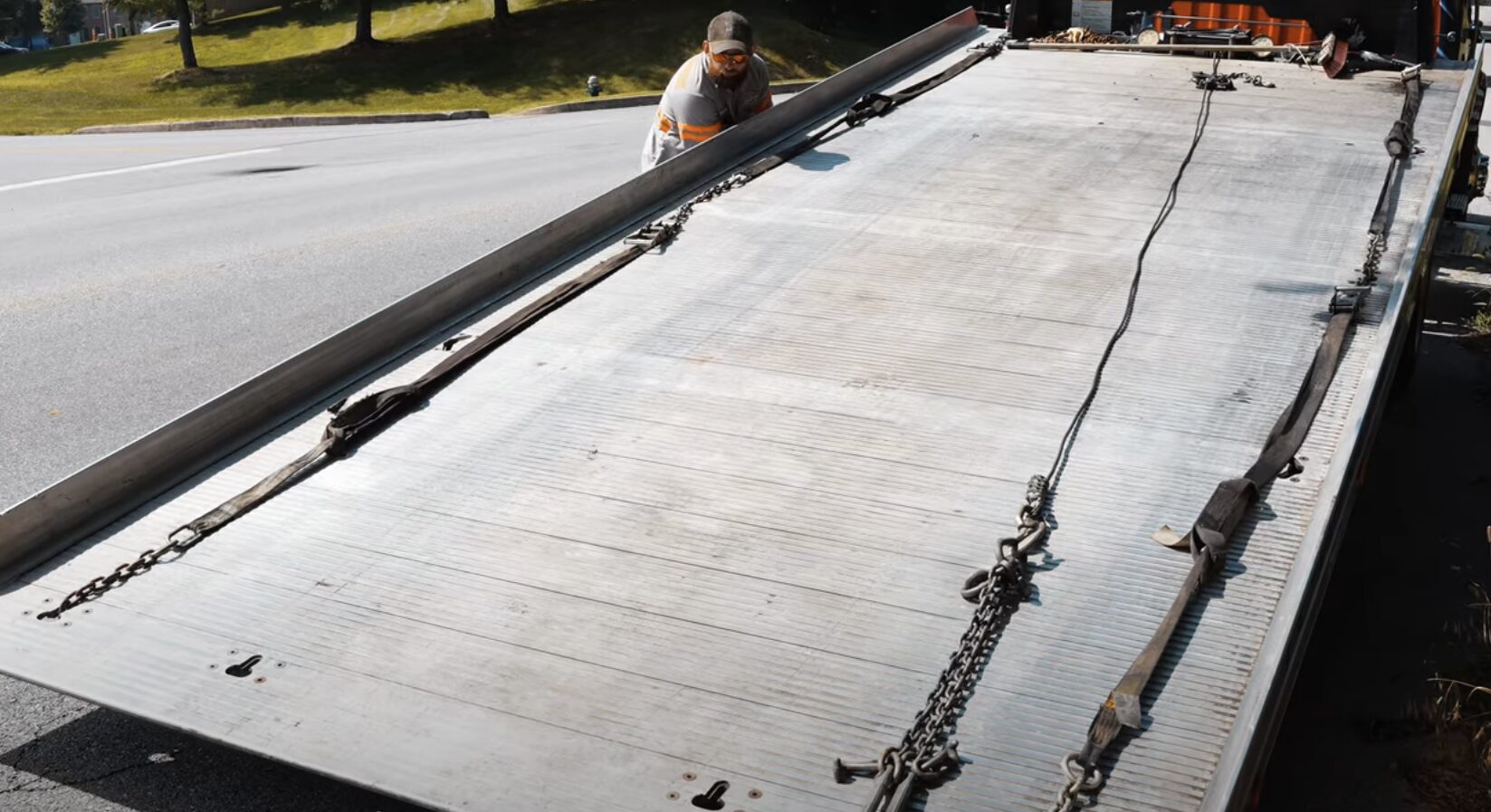 Safe Roadside Vehicle Recovery Service in Friendswood, TX Flatbed tow truck preparing for safe vehicle loading